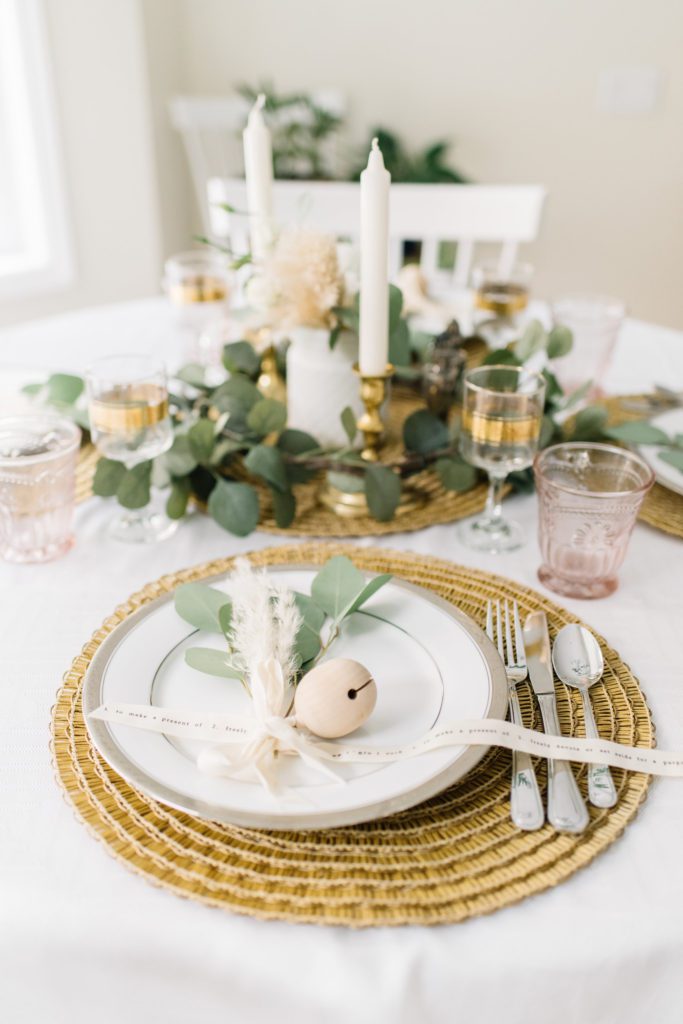golden thanksgiving table with seagrass place mats and wooden ornaments