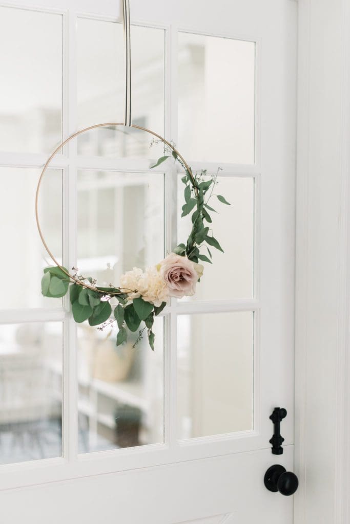 Simple fall decorating idea- a floral hoop hung on ticking stripe ribbon