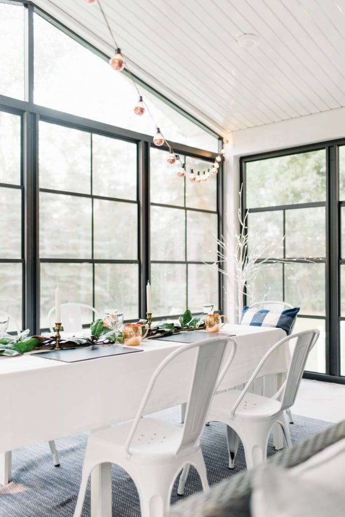 A sunroom with black floor to ceiling windows