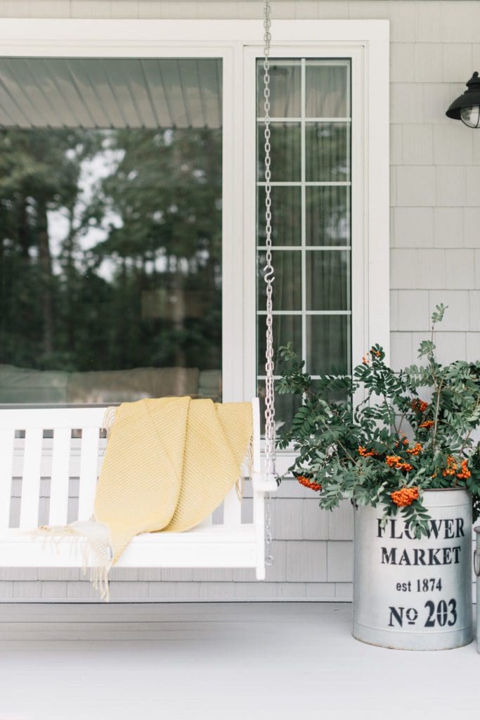 Foraged berry branches in galvanized tubs are a simple way to decorate the front porch for fall