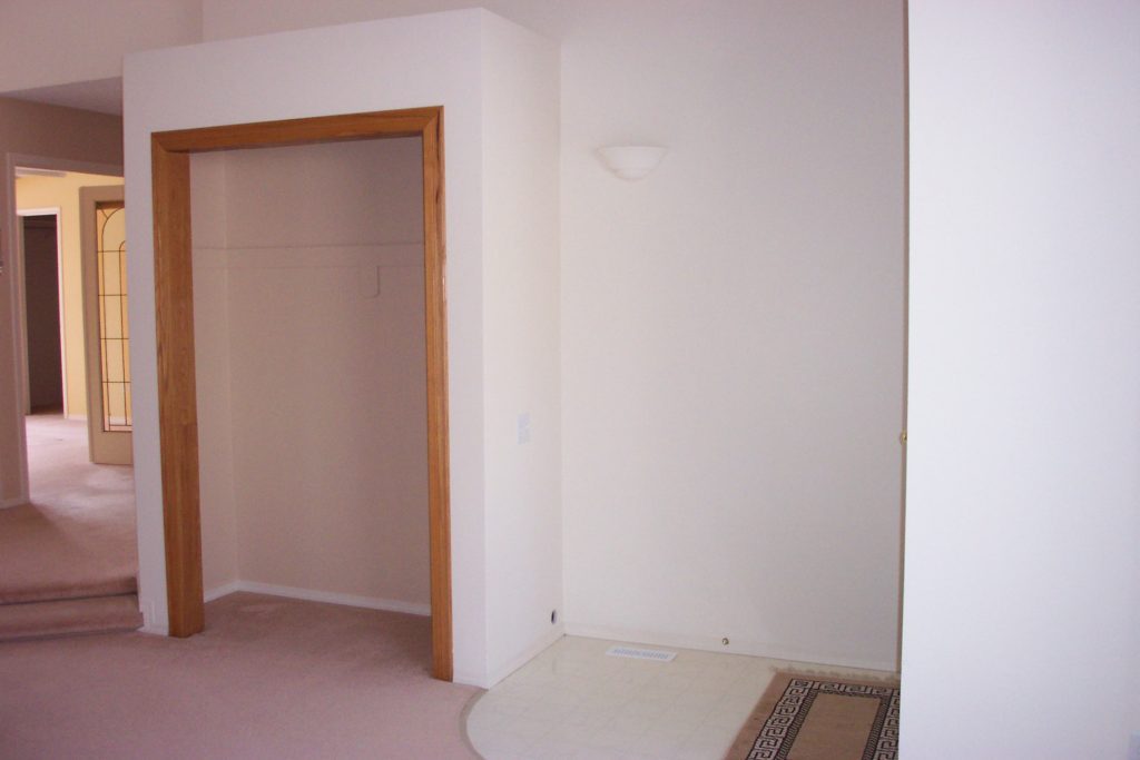 Outdated 90s house with small entry and awkward closet before renovation