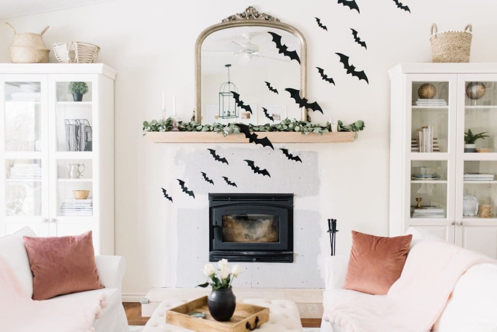 Paper bats fly across the fireplace for Halloween at The Ginger Home