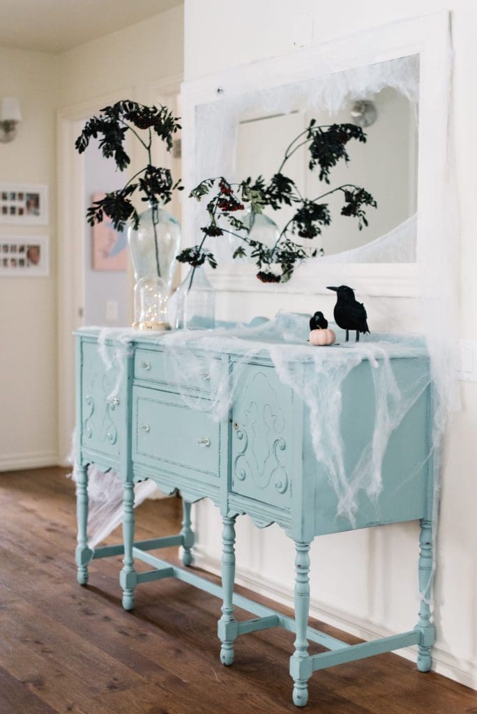 Branches, cobwebs and crows make a spooky hallway vignette for Halloween