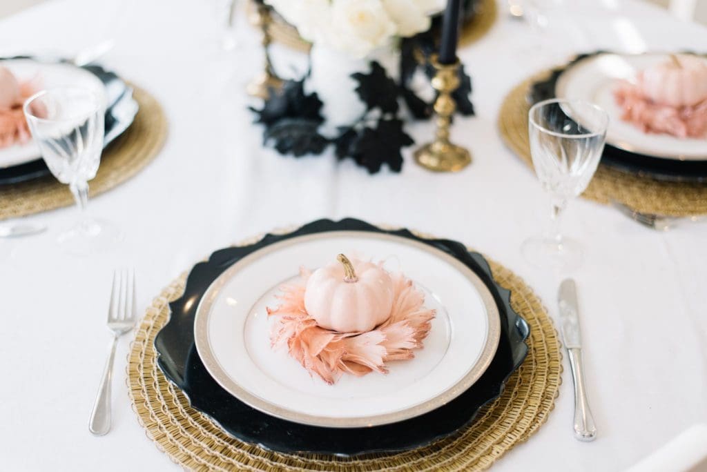 mini pink pumpkin on a feather wreath