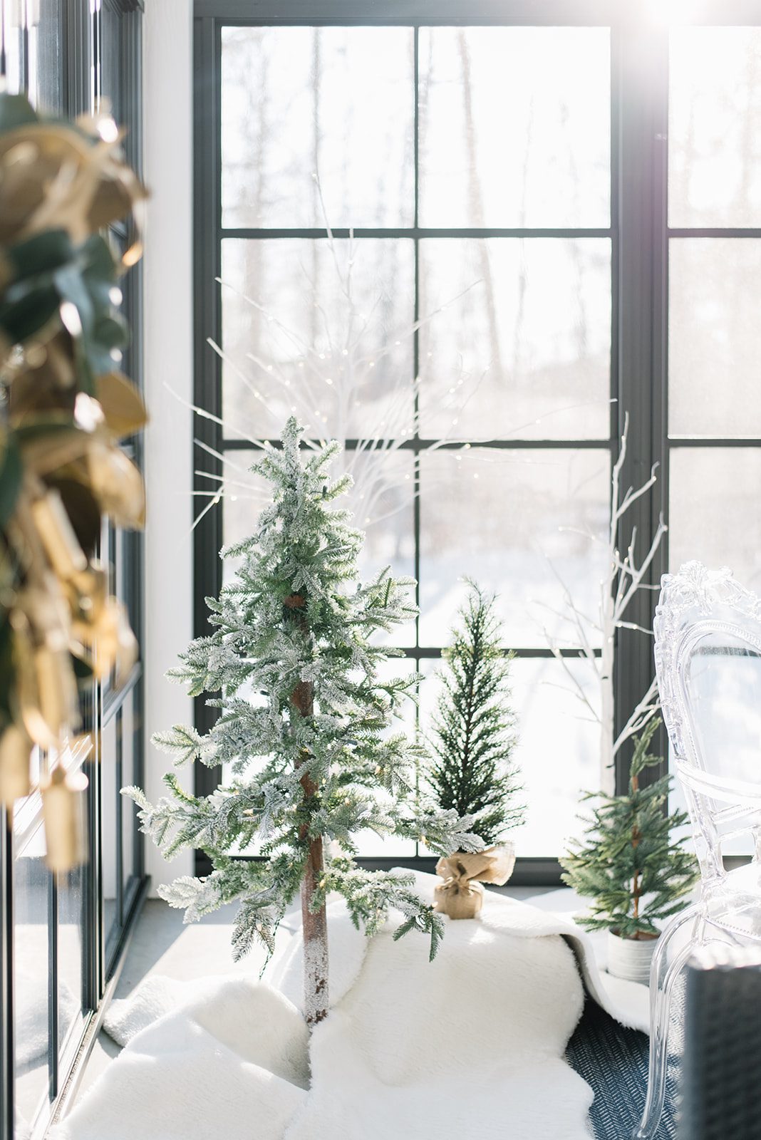 faux Christmas trees in a sunroom