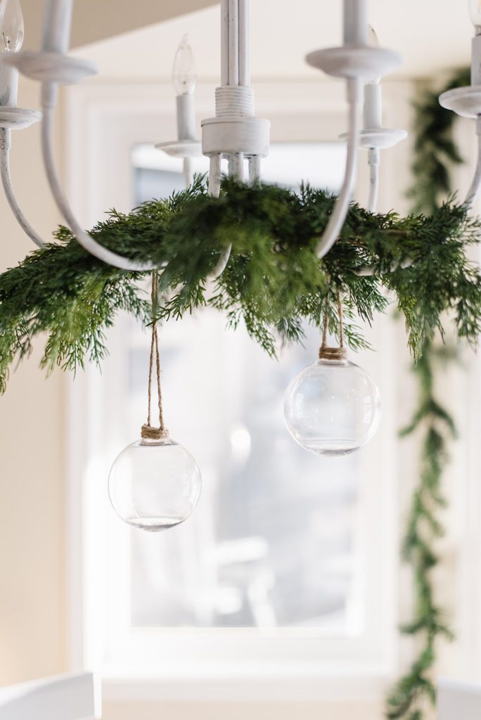 Simple greens hung on the chandelier add a festive touch at The Ginger Home