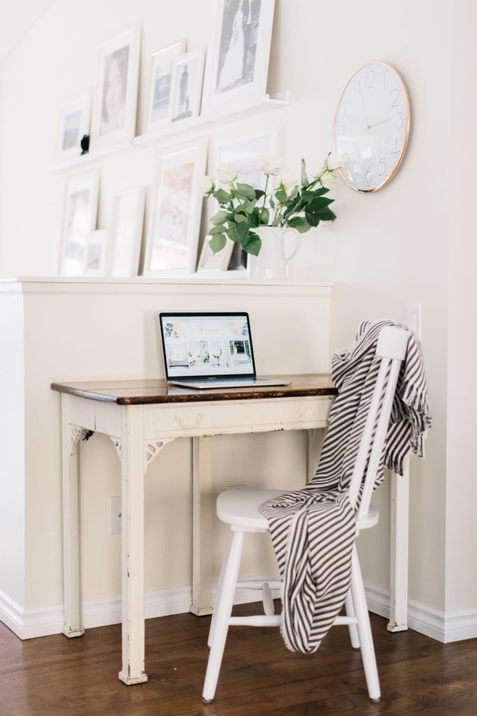 Small table doubles as desk in a hallway nook