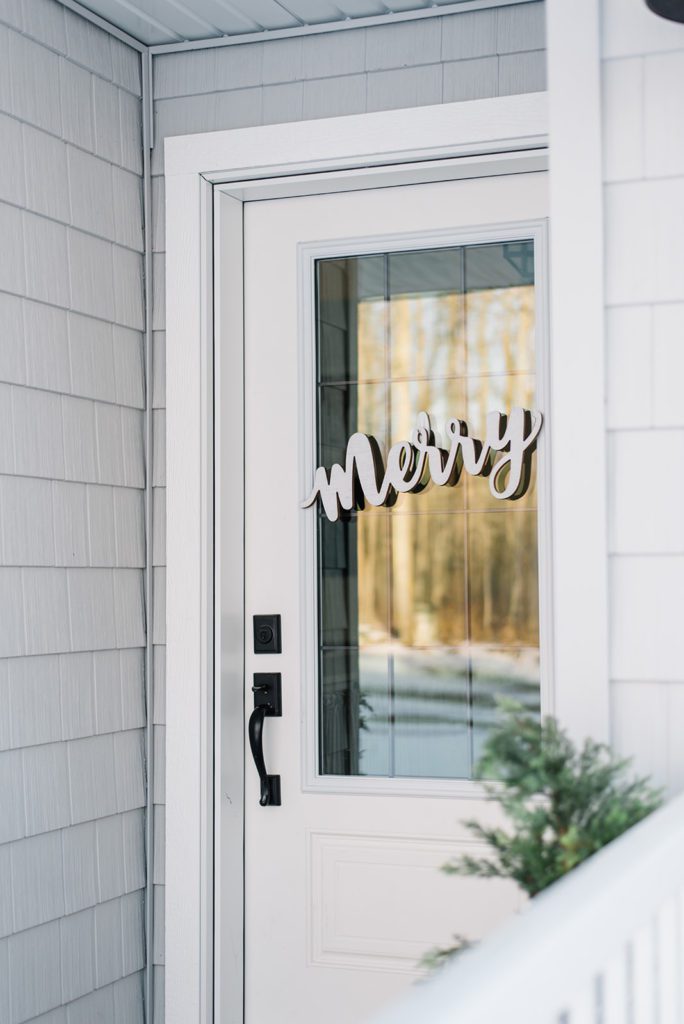 Custom wooden letter sign on the front door for Christmas at The Ginger Home