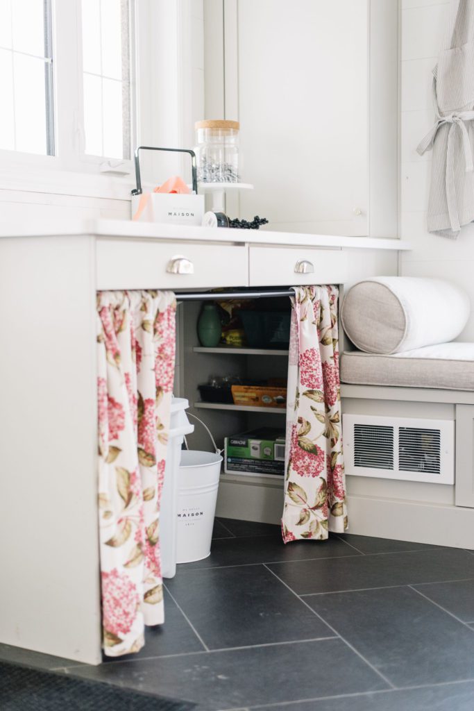 Curtains instead of cupboards in the mudroom hide clutter and allow for storage of larger items 