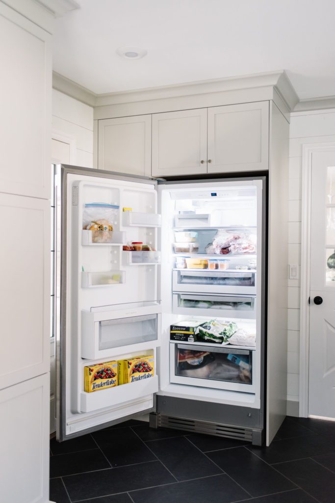 An extra freezer provides overflow storage for the kitchen