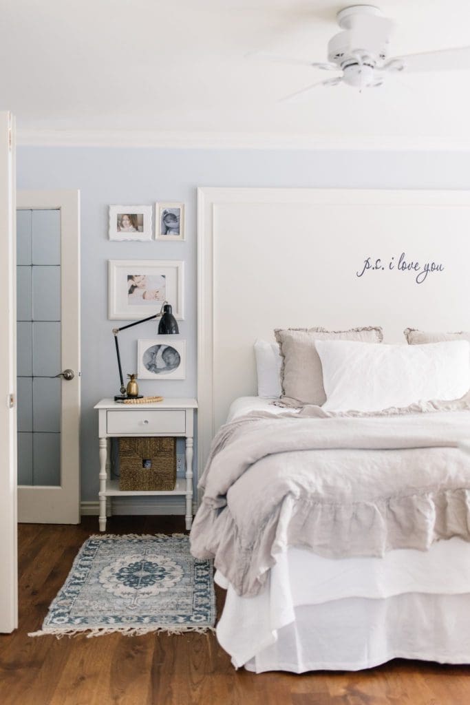 Bedside tables with drawers and baskets maximize storage in this small master bedroom