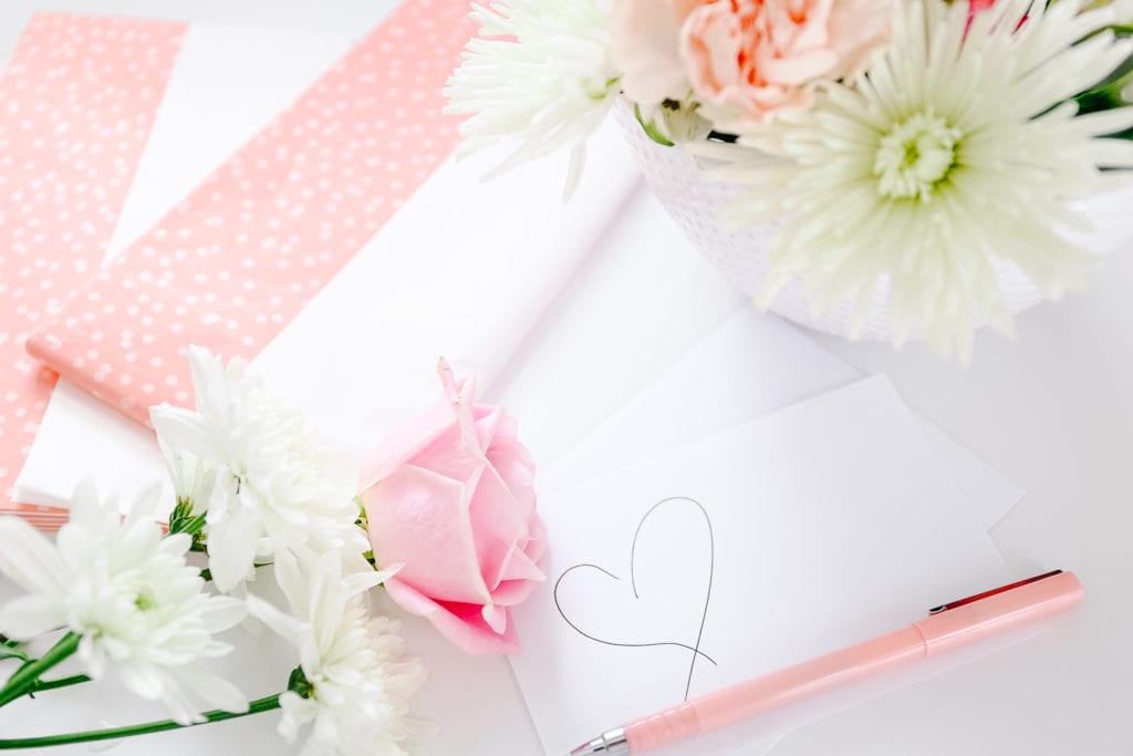 handwritten note on a table with flowers