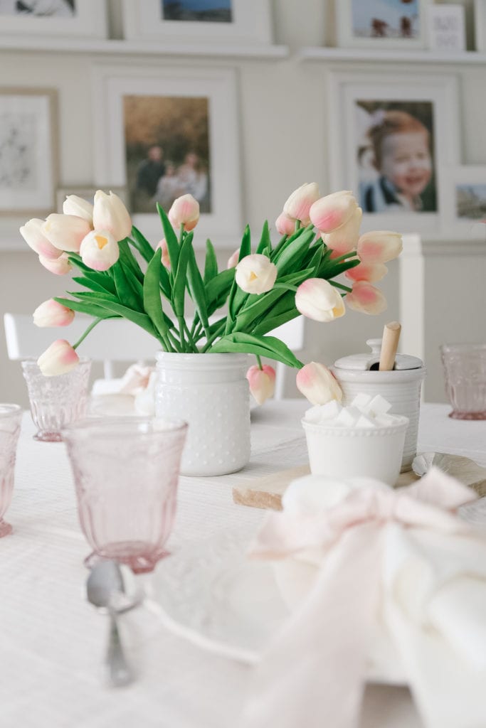A vase of tulips on a table