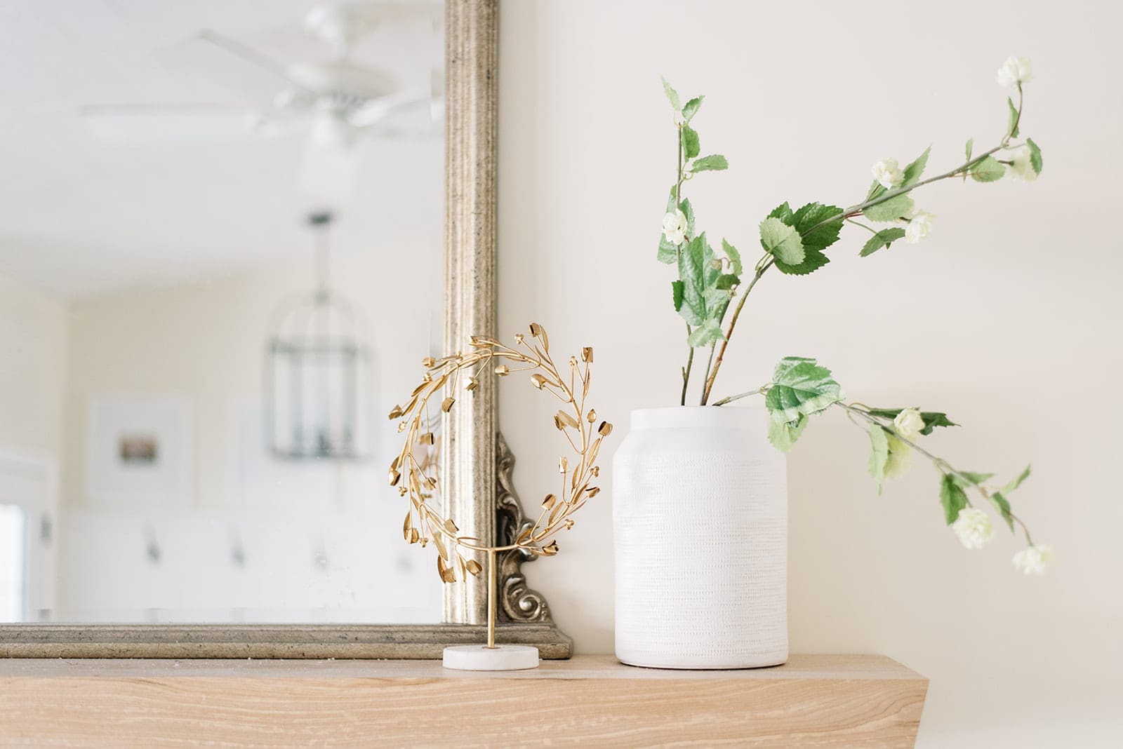 A vase of flowers on a mantle - post christmas winter decorating idea