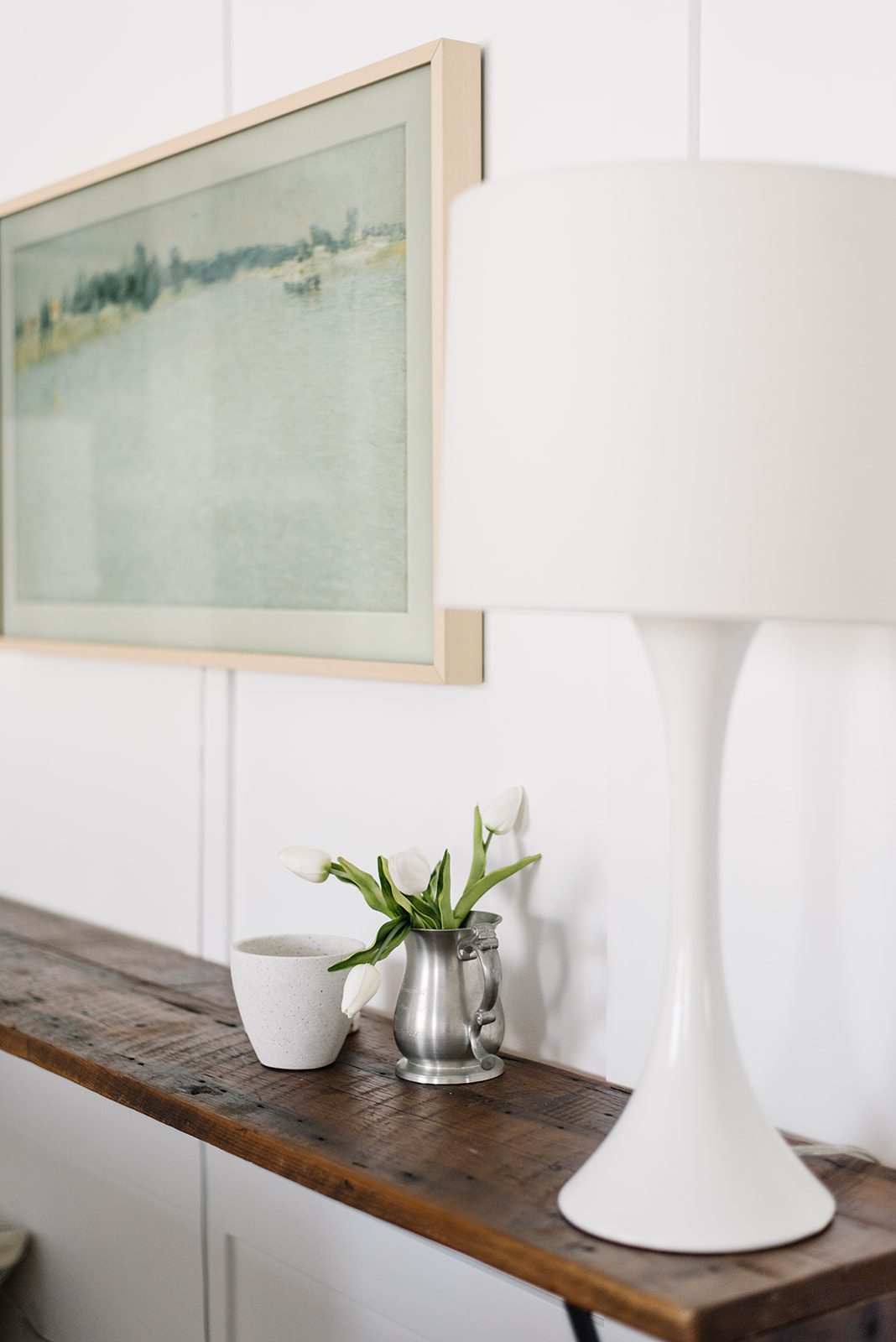 white lamp on a wooden console table