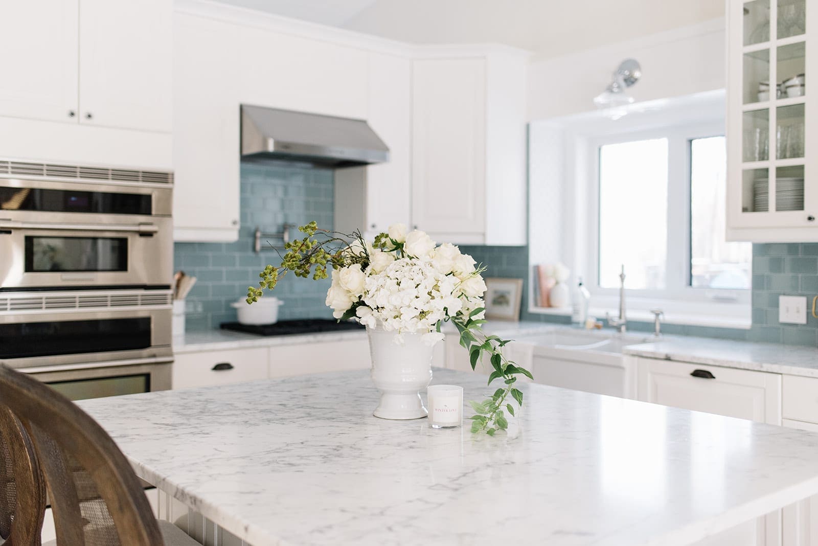 large white flower arrangement on kitchen island