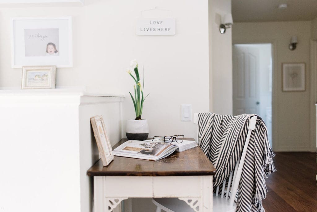 A small table with a plant and book