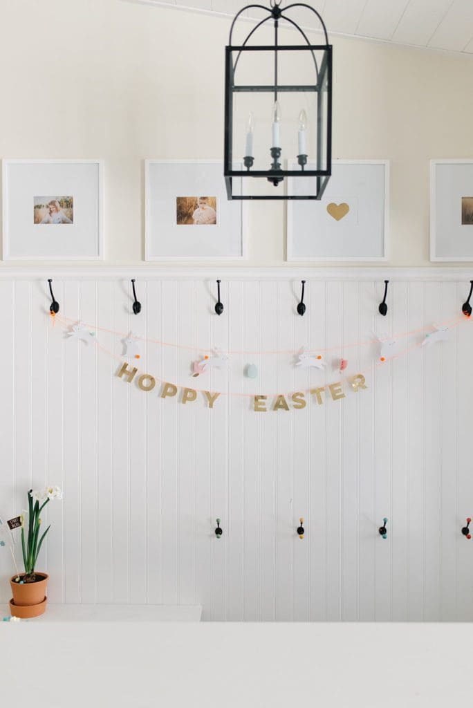 A Hoppy Easter garland hung on entryway hooks