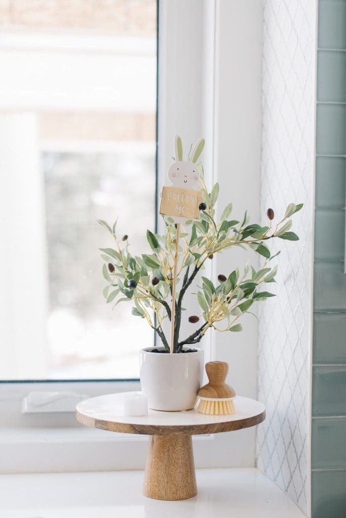 A plant with an Easter Egg hunt sign on a pedestal