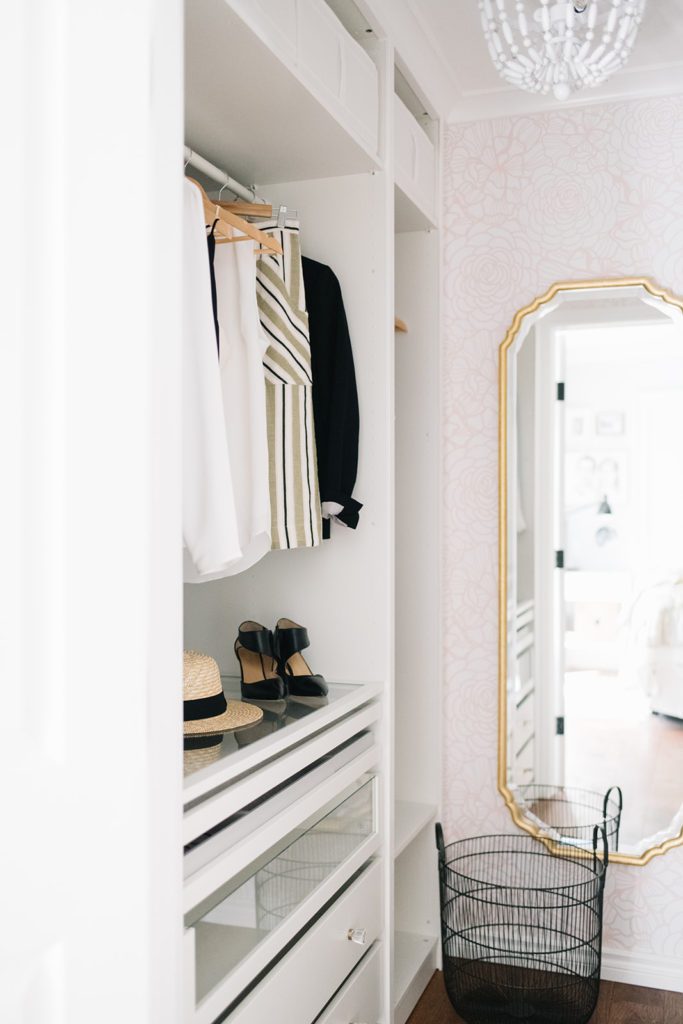 A custom closet renovation using Ikea pax wardrobes and pink wallpaper