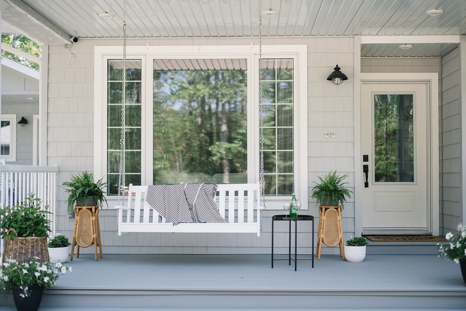 Summer front porch inspiration - porch swing, greenery and white blooms
