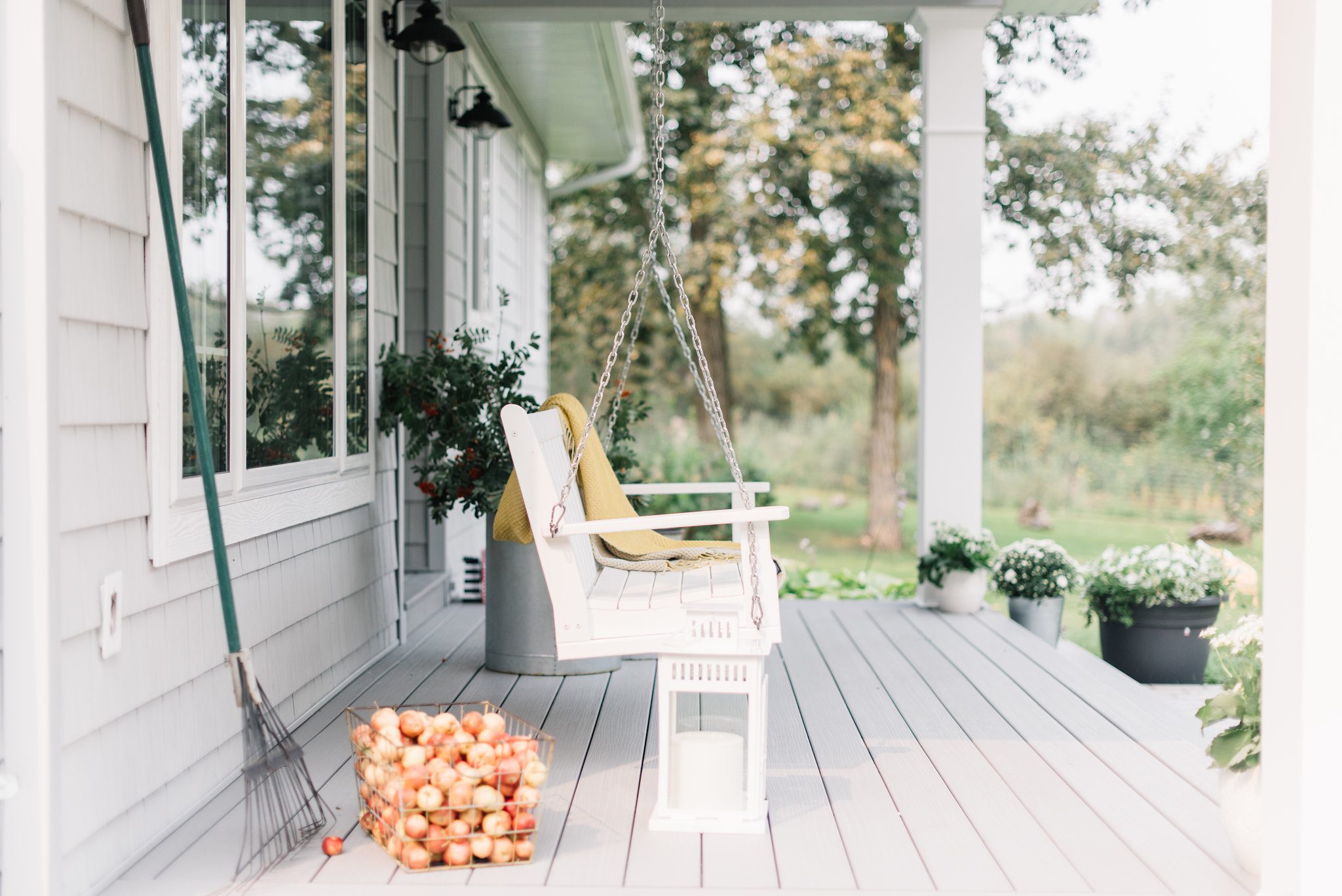 fall front porch with swing and basket of apples