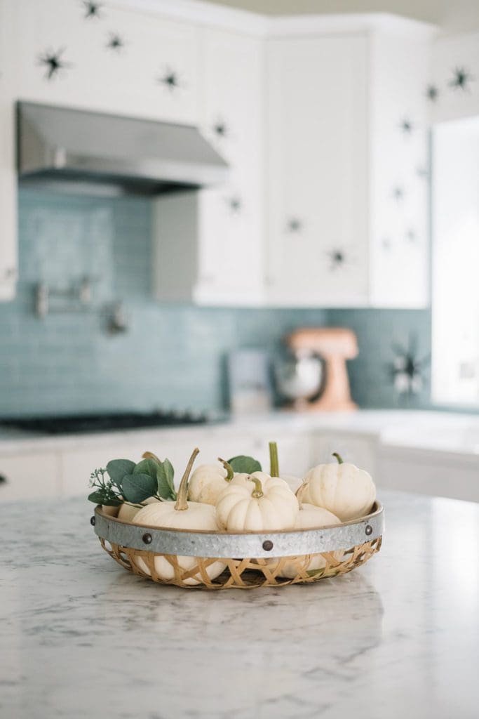 basket of tiny white pumpkins on kitchen island