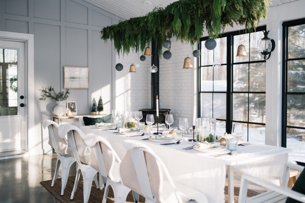 A modern country Christmas tablescape with fresh garland