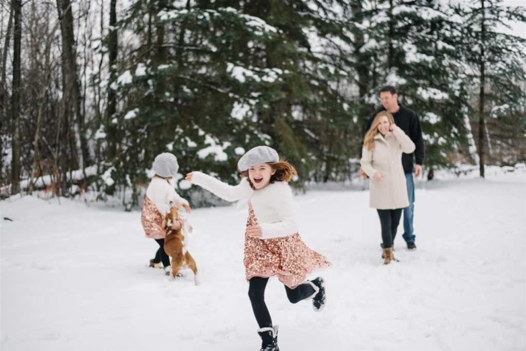 Family plays in the snow