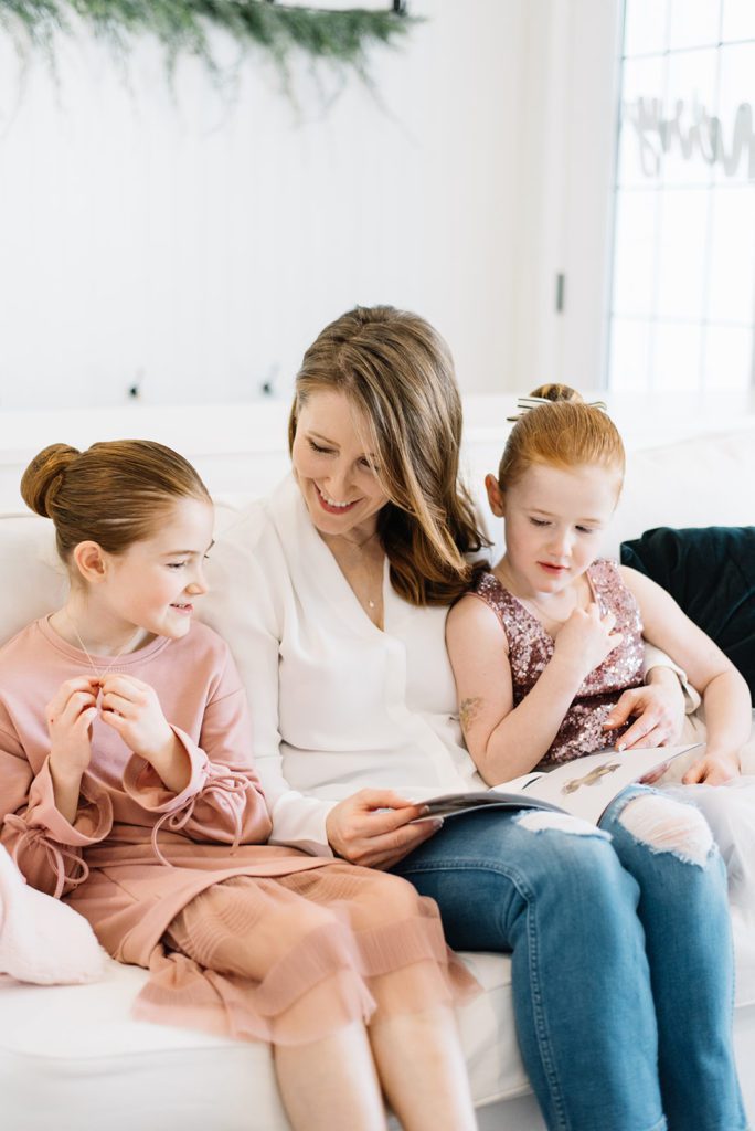 Mom and daughters reading a book