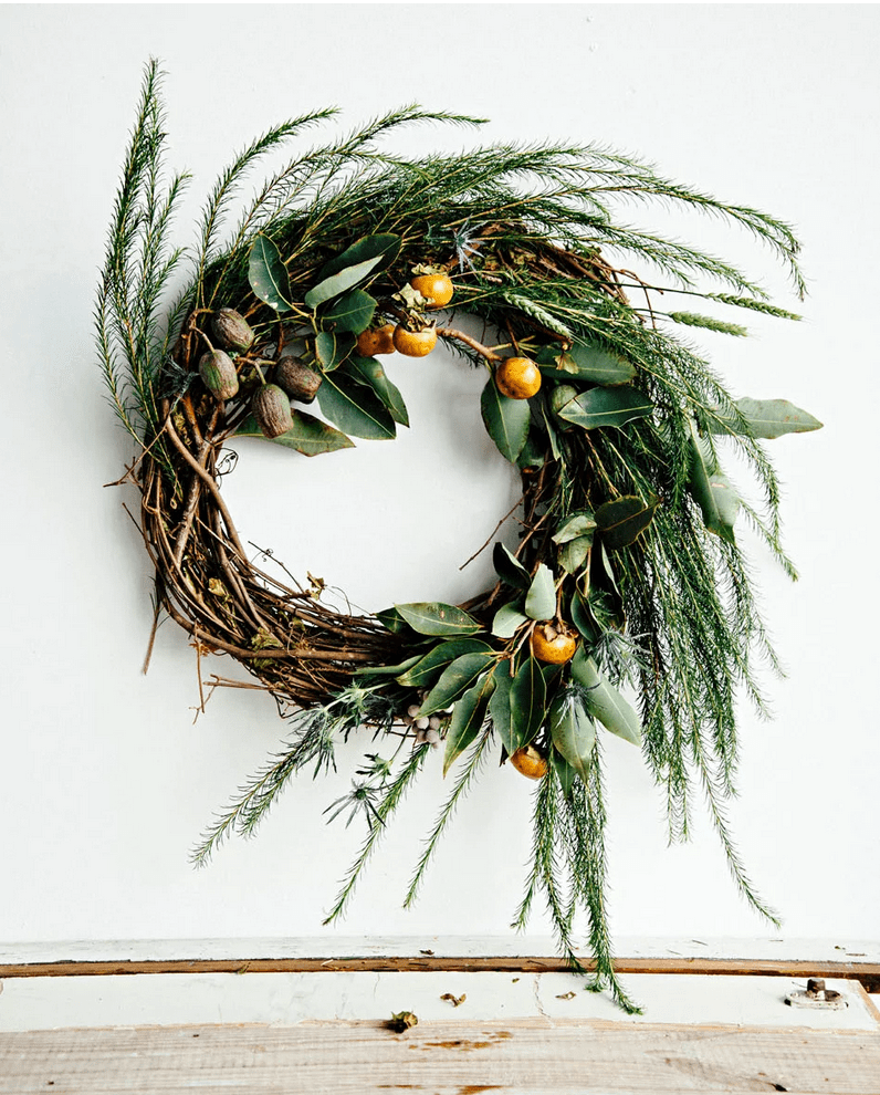 Adding fresh greens to a standard wreath takes it from boring to beautiful!
