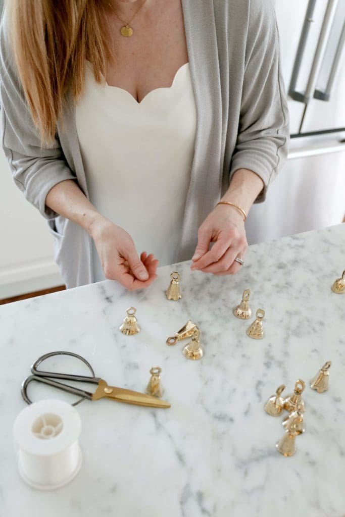 using brass bells hung on fishing wire to make a garland