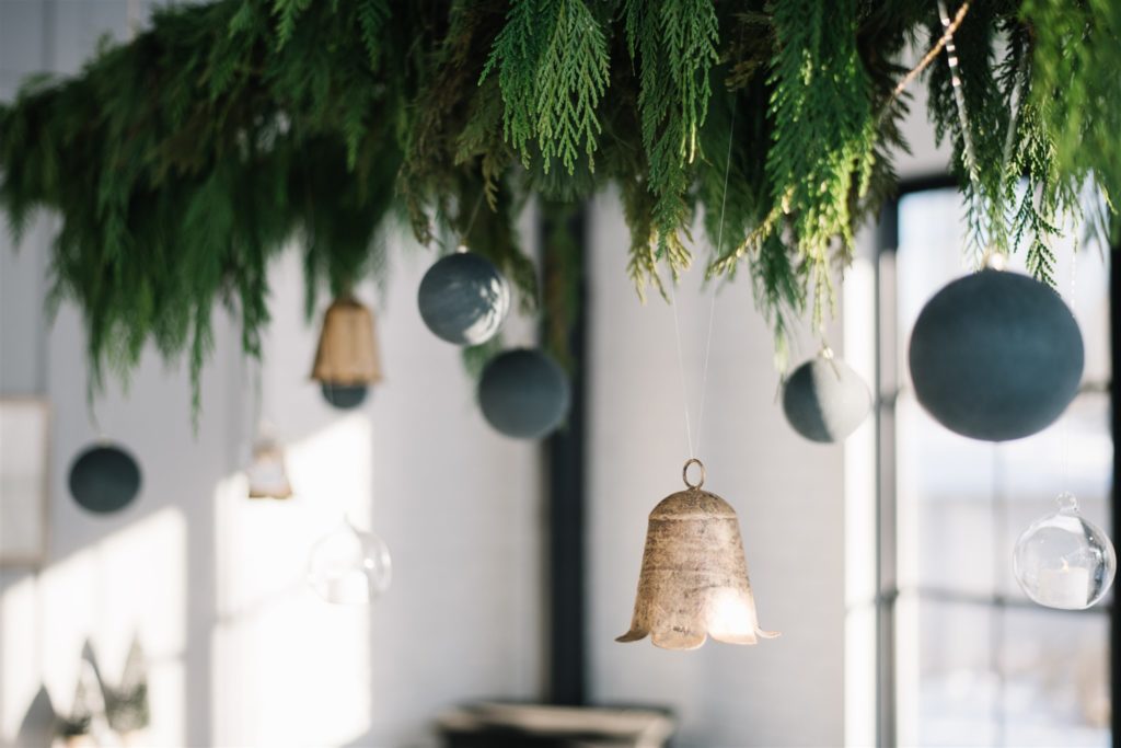 Ornaments hung from fresh garland above the table
