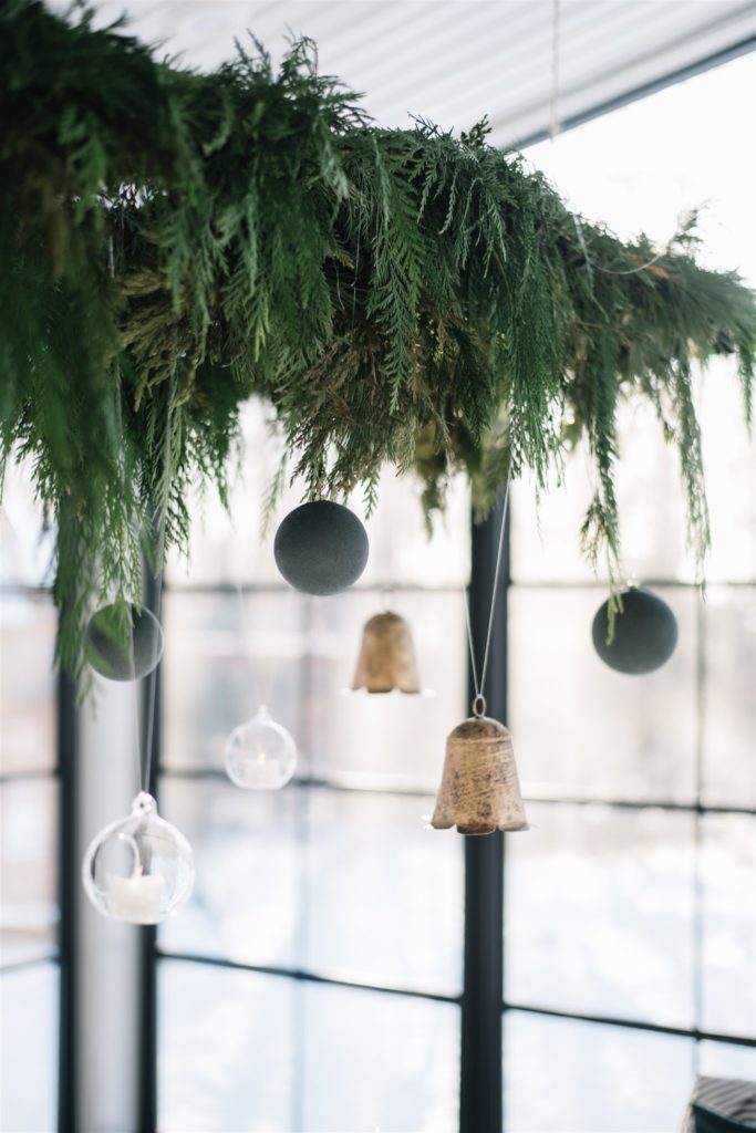 Ornaments hanging from a fresh garland installation