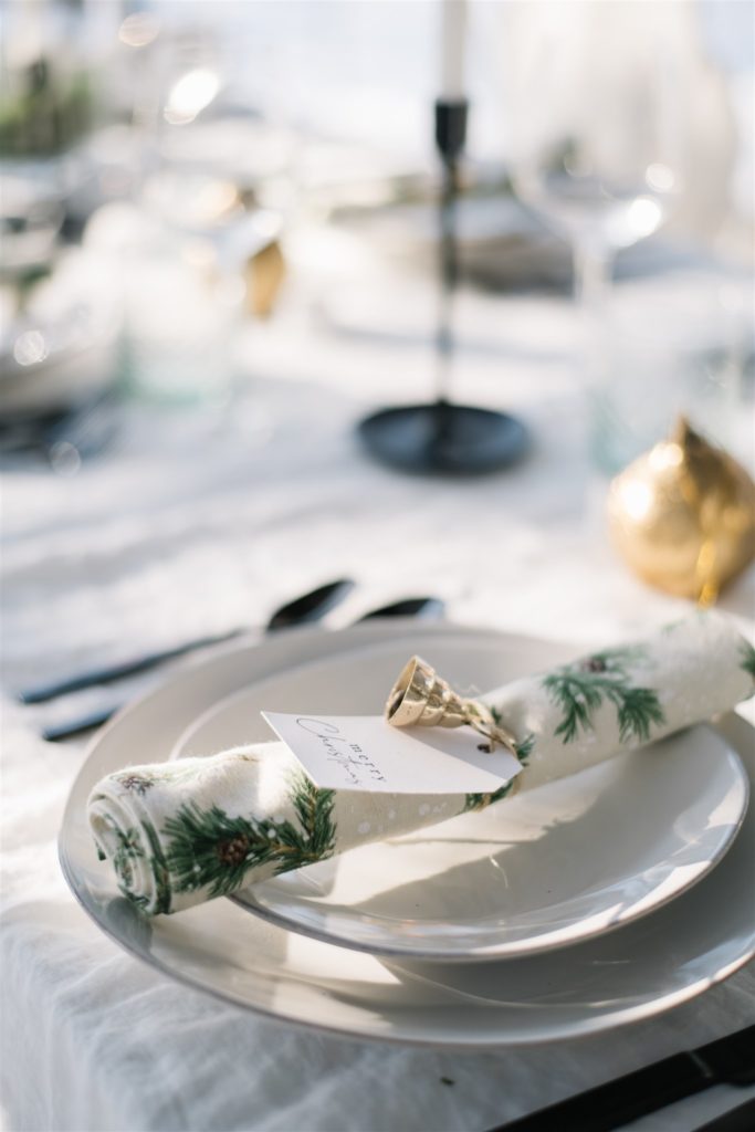 christmas napkin tied with a brass bell