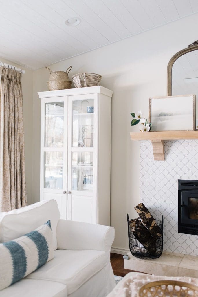 A living room with white bookshelf