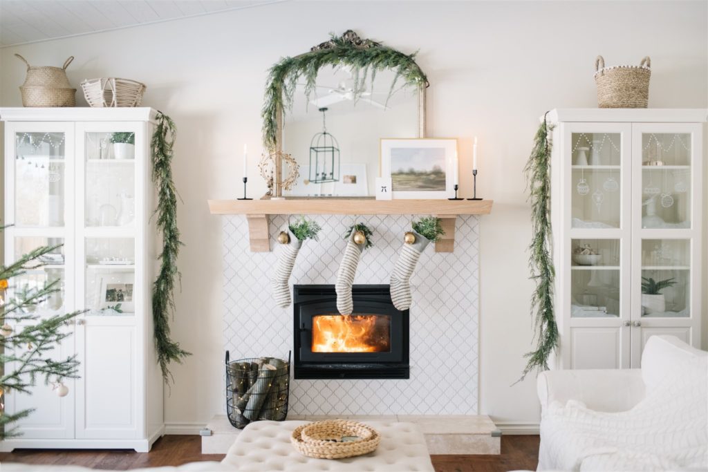 A fire roaring in the fireplace and candles lit on the mantle make the living room cozy