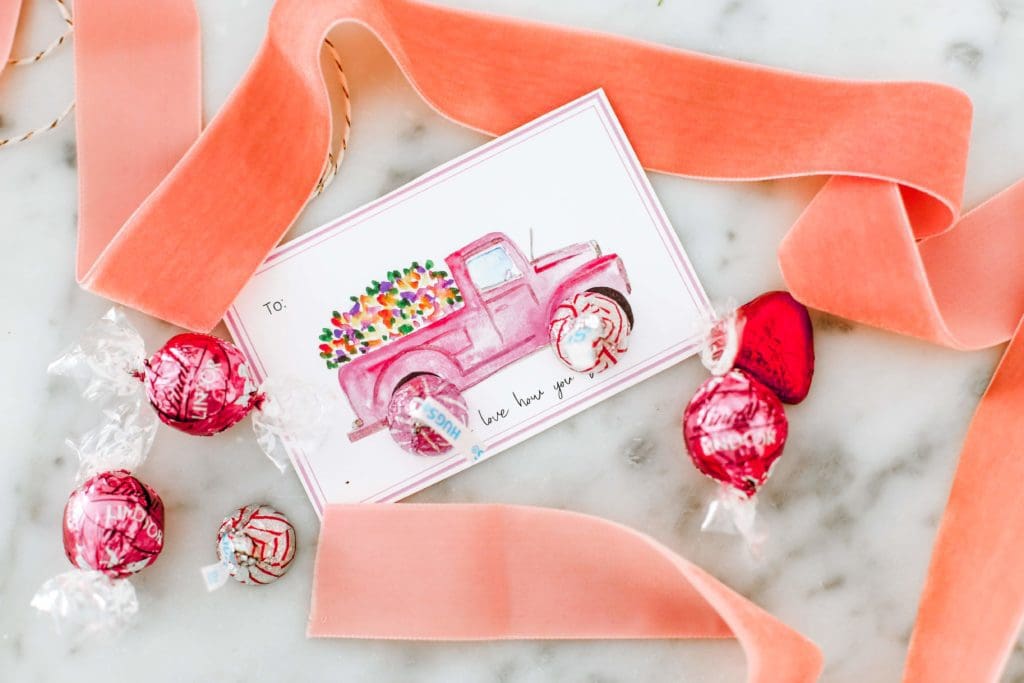 Valentine\'s day card with pink ribbon and candy on marble counter