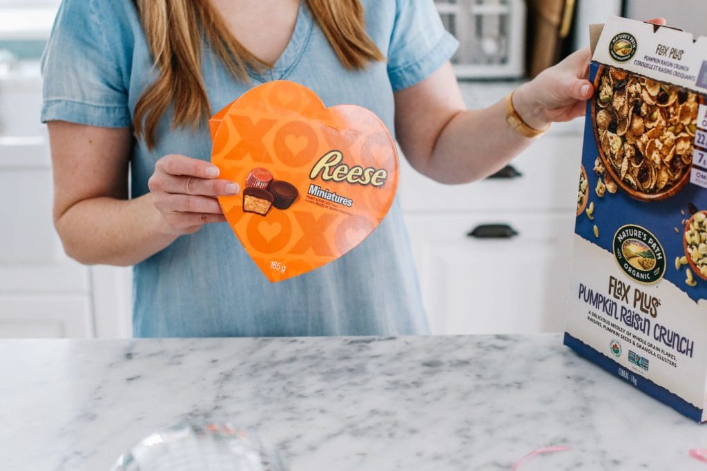 A woman holding a heart shaped box