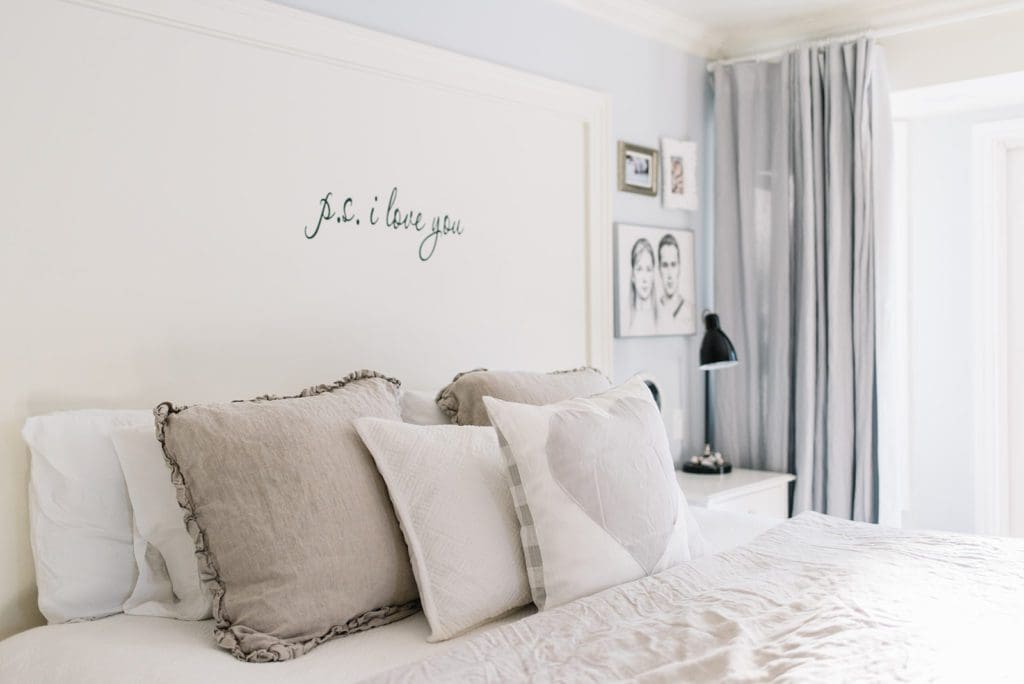 Layered pillows on a king size bed in a small master bedroom