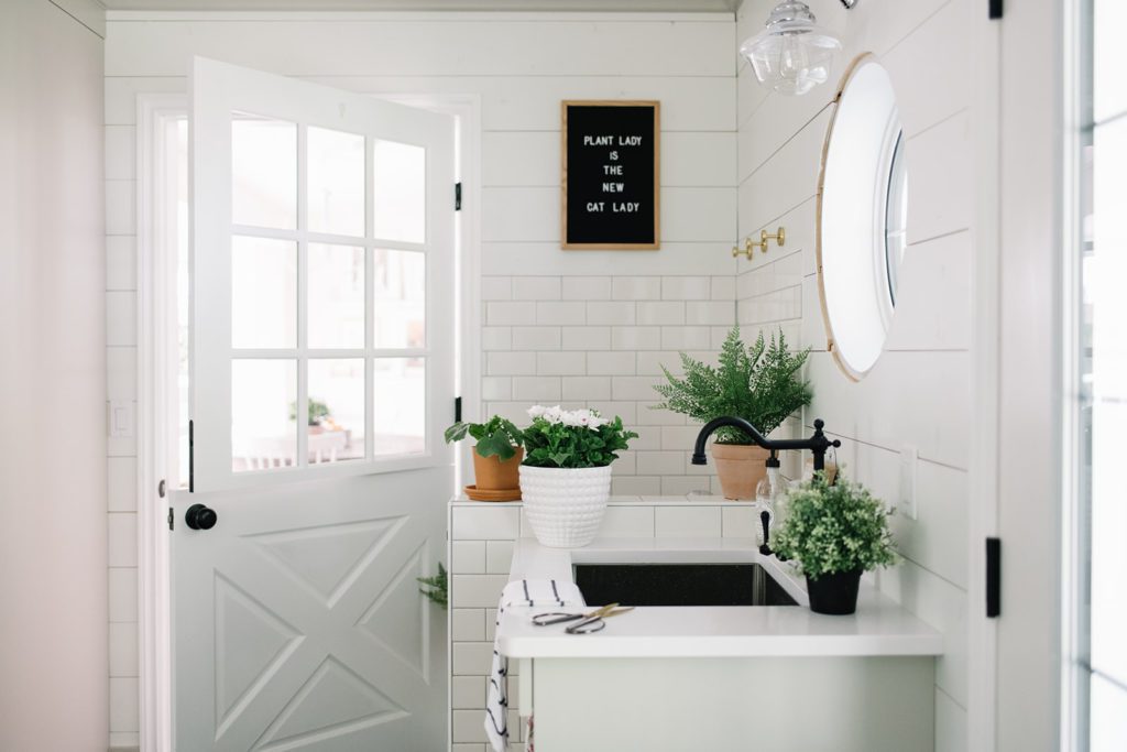 A mudroom sink area with potted plants - simple spring home decor ideas