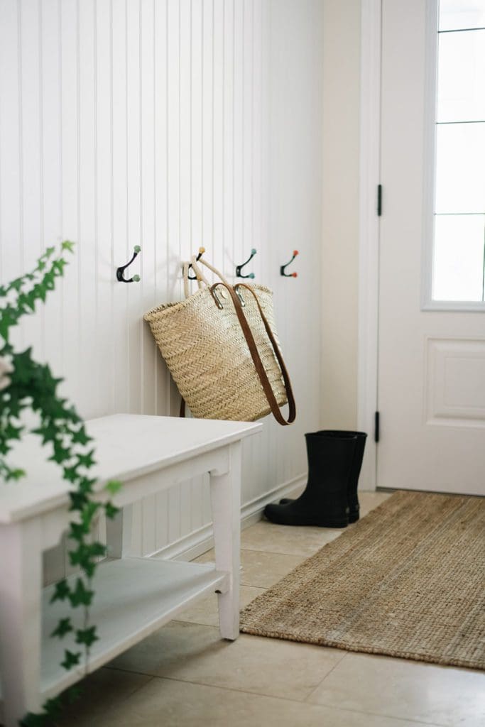 French market basket and rubber boots sit by front door