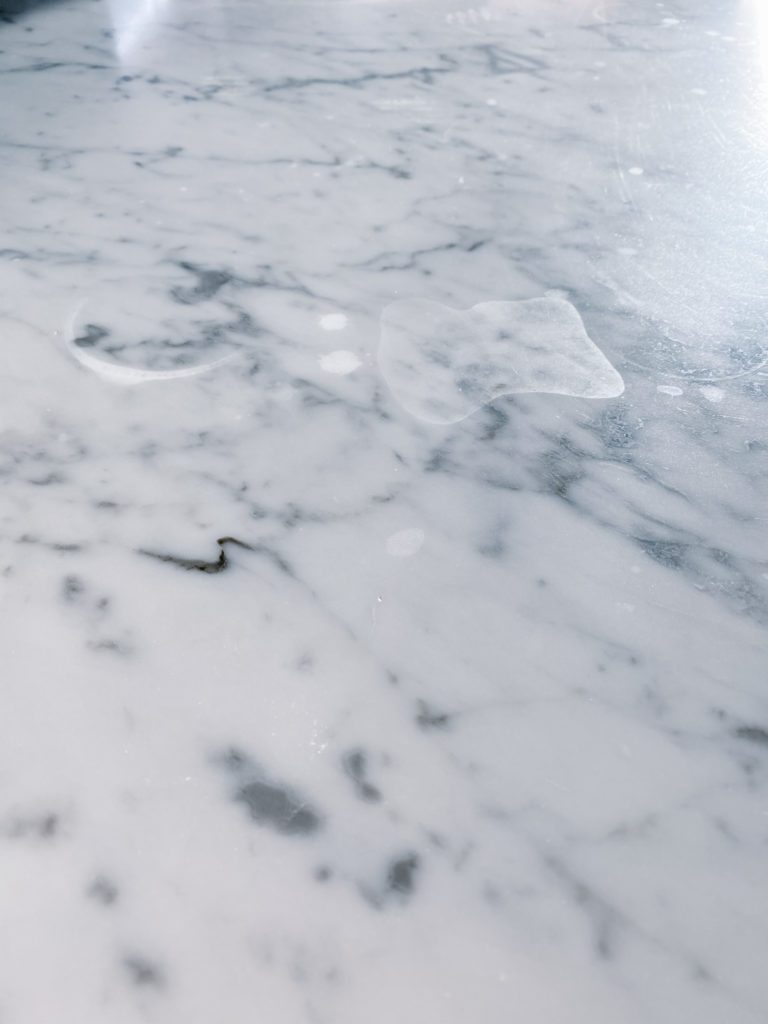 A close up of etching on marble counters