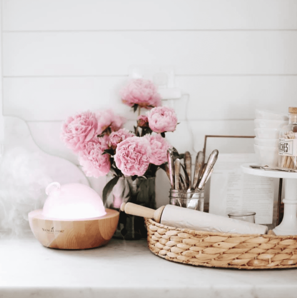 A vase of flowers on a kitchen counter with a diffuser - simple spring decor ideas