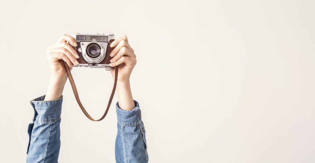 A vintage camera being held up