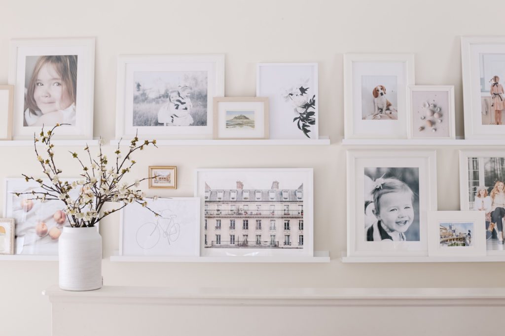 a simple spring home decor idea - a gallery wall filled with white frames and seasonal prints
