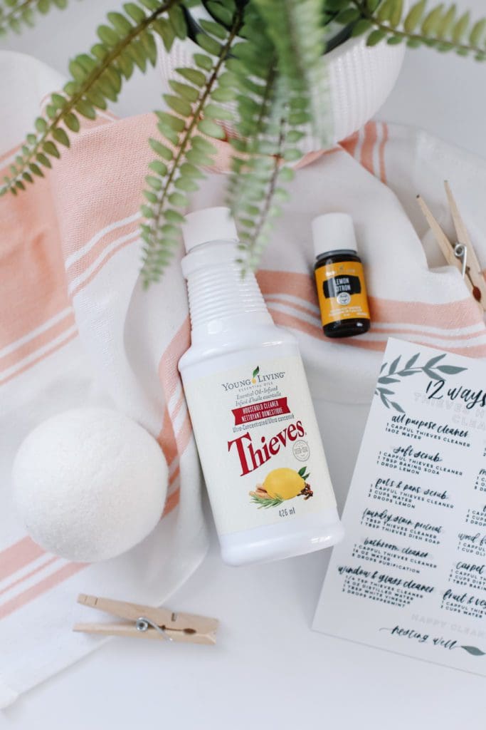 A bottle of Thieves Cleaner lying on a pink towel 