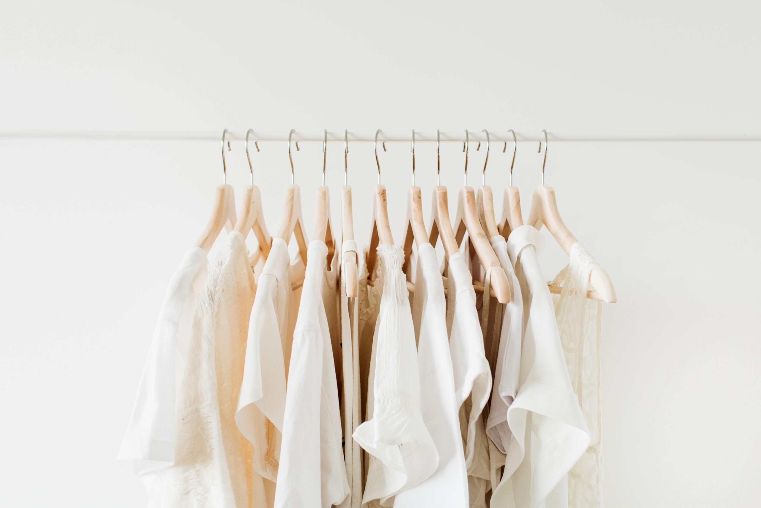 neutral clothing hanging on a rack