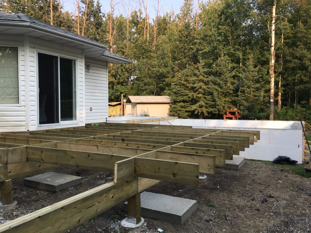 a deck being built on the back of a house