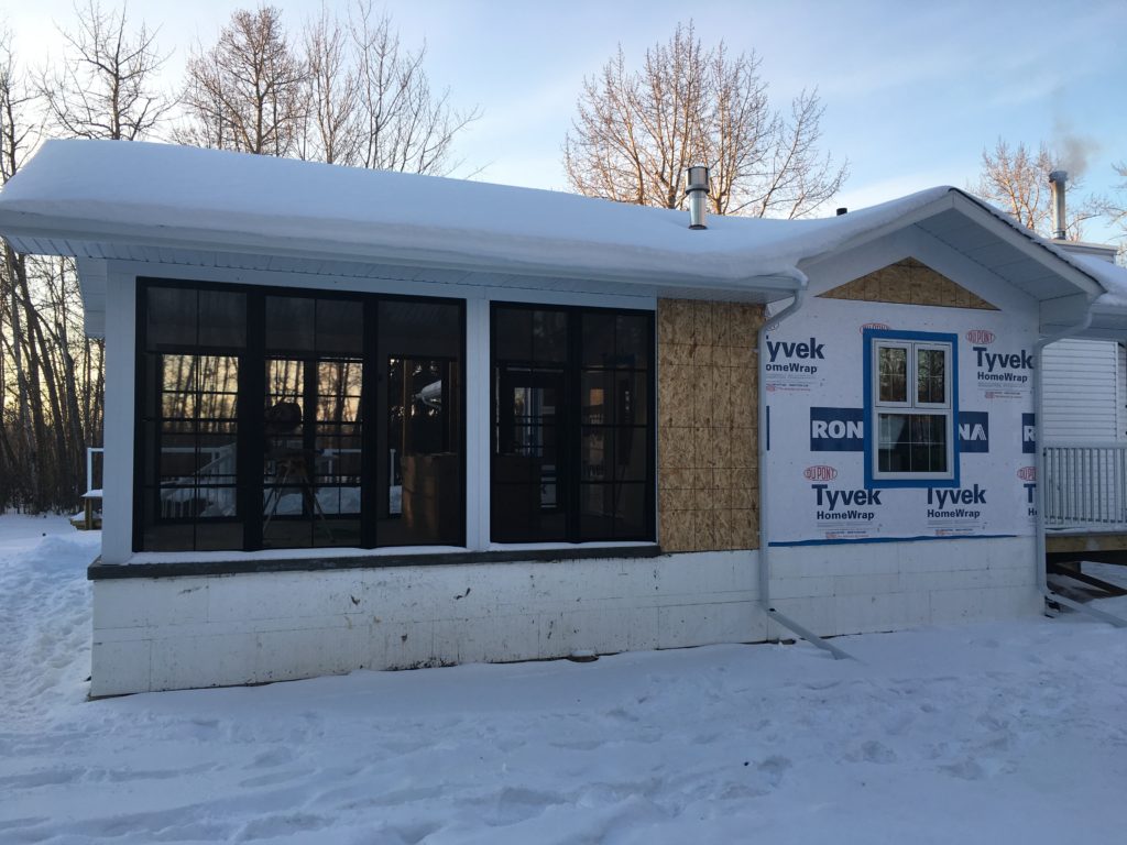 partially finished home addition covered in snow